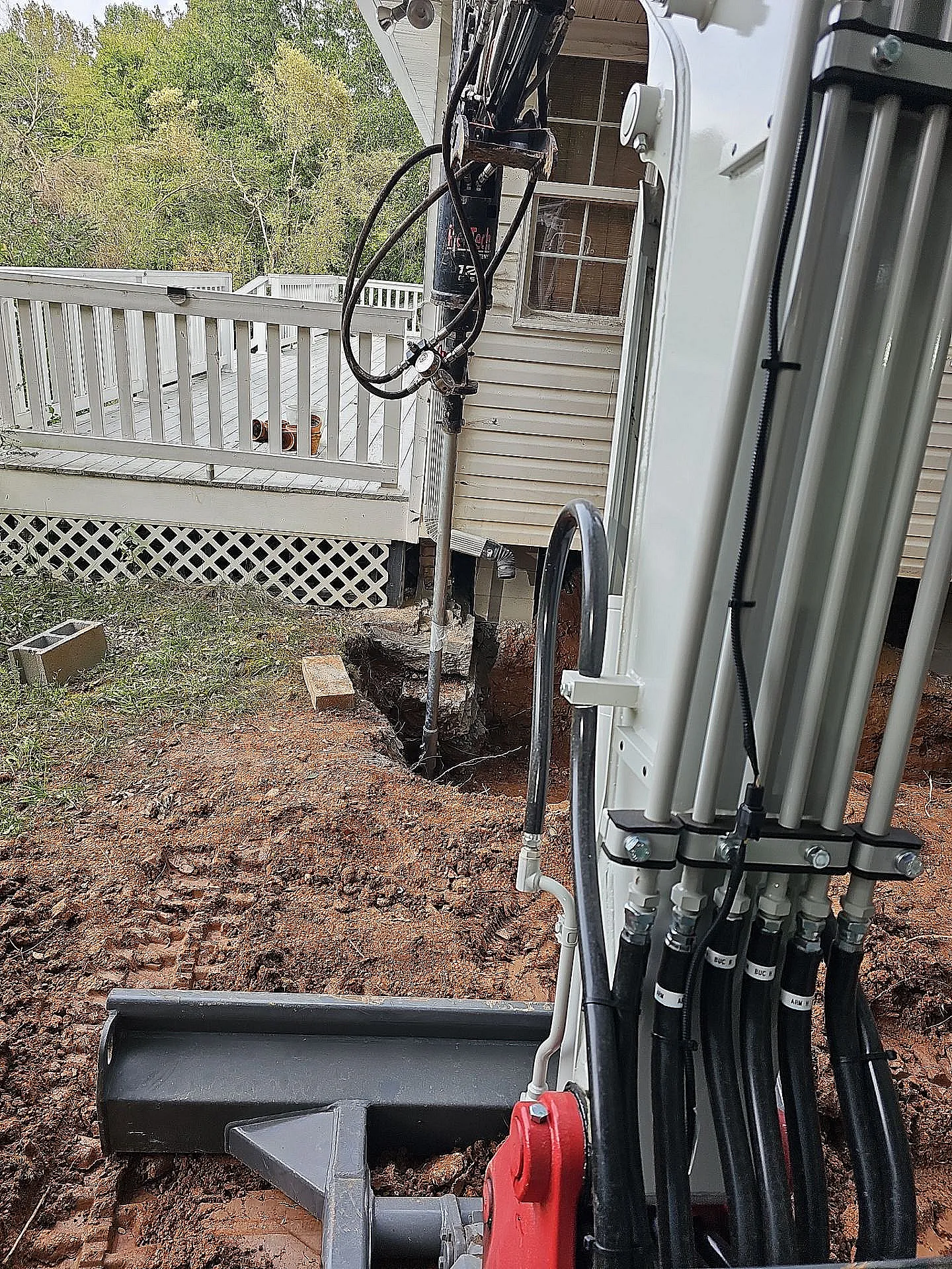 Installation of helical piers to stabilize a home's foundation